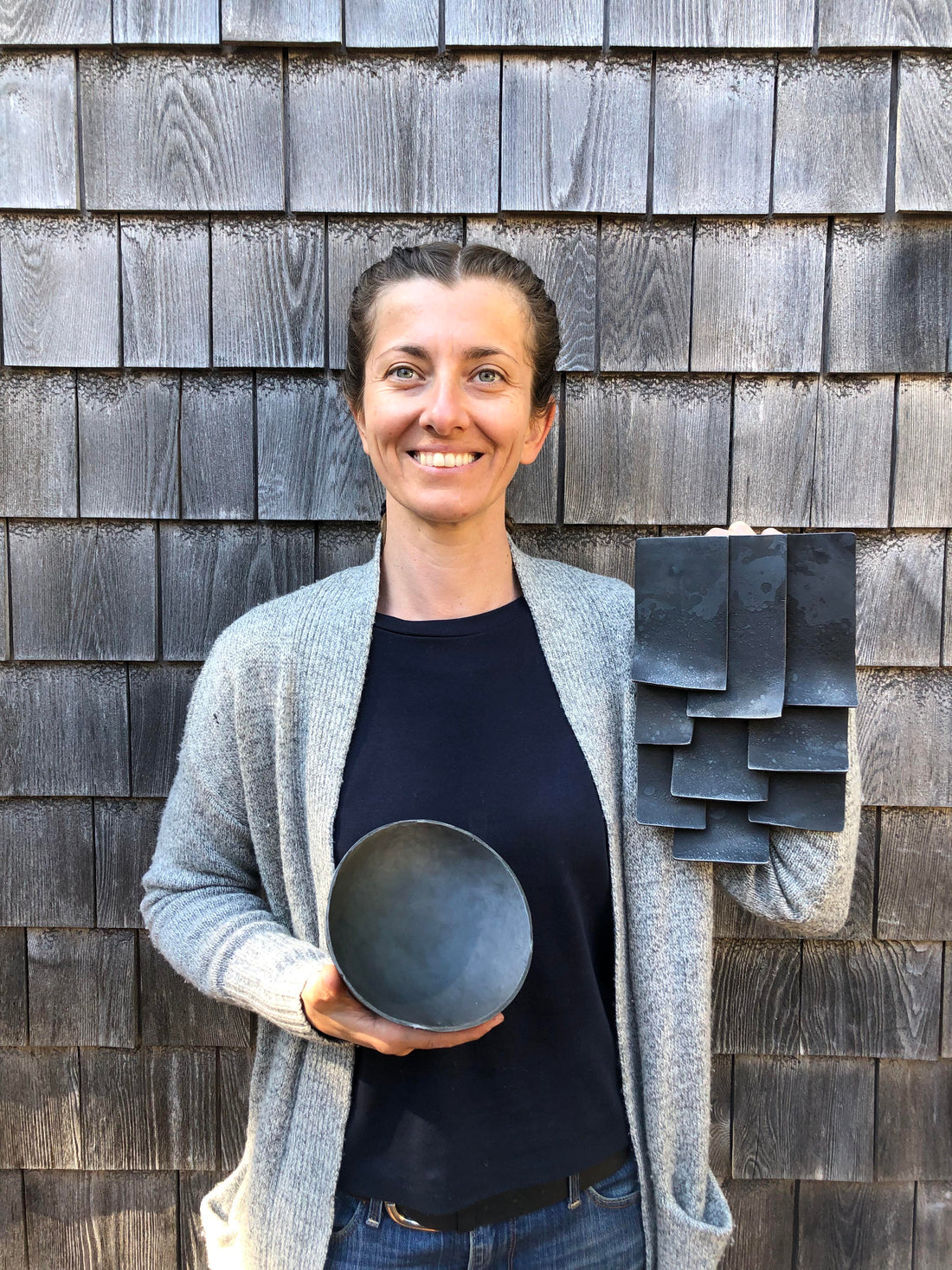 Mia Hebib holding her pieces she created at Haystack Mountain School of Crafts