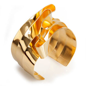 This cuff bracelet is hand formed out of strips of brass coiled into a continuous flowing ribbons. The bracelet is called Continuity as it reminded me of Umberto Boccioni's "Unique Forms of Continuity in Space"... this bracelet is plated in 14k gold.  ~Approximately 1.5-1.75" wide.  Each piece is hand fabricated, which means this sculptural bracelet is light to wear and adjust easily to fit your wrist.  Made in brass and finished in 14k nickel free gold plating.