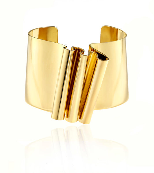 This is sculptural, yet not voluminous bracelet. Interesting ripple on the front surface makes this a unique cuff. It is an everyday piece, easy to wear and can be for playing dress up or just to bring out your inner Barbarella!  ~1.5" wide in size and it sits about .4" above with the ripples.   Each piece is handmade-please allow slight variance.  Hand fabricated in brass and finished with 14k nickel free gold plating.