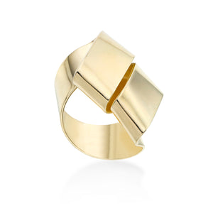 Double wrapped ribbon-like ring called Change Agent. It is hand formed in brass and finished with 14k gold plating.