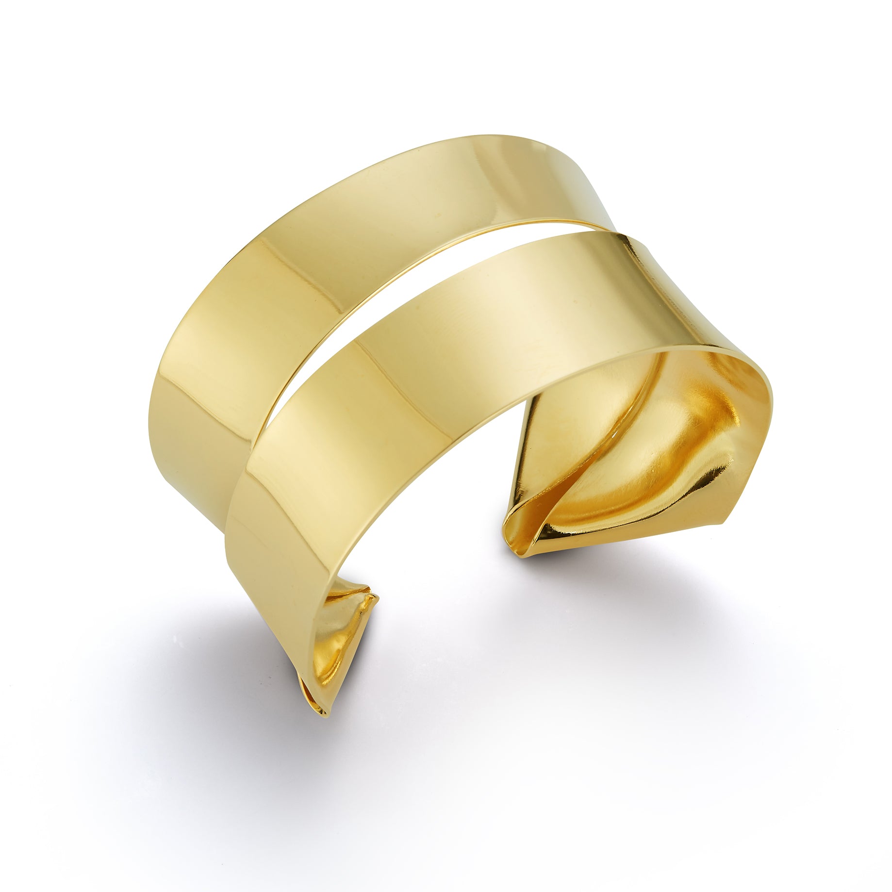 A lighter cuff on the repertoire. I have created this piece out of a single sheet of metal. It is completely formed and can be worn showing the ends on the front or the wide strip on the front. ~1.5" wide   ~fabricated out of a single brass sheet and finished in 14k nickel free gold plating  Bracelet is light and can be adjusted to fit the wrist. Slip on gently due to the ends but adjust by softly squeezing to fit around your wrist a little less loosley. 