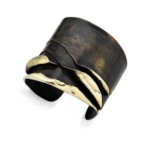 This is a piece of art cuff bracelet. Hand fabricated out of 4 separate brass sheets. Each is hammered and bent as though it's being peeled from a core. A sculptural piece of jewelry and very unique.  ~ about 2" wide   ~ brass with patina finish
