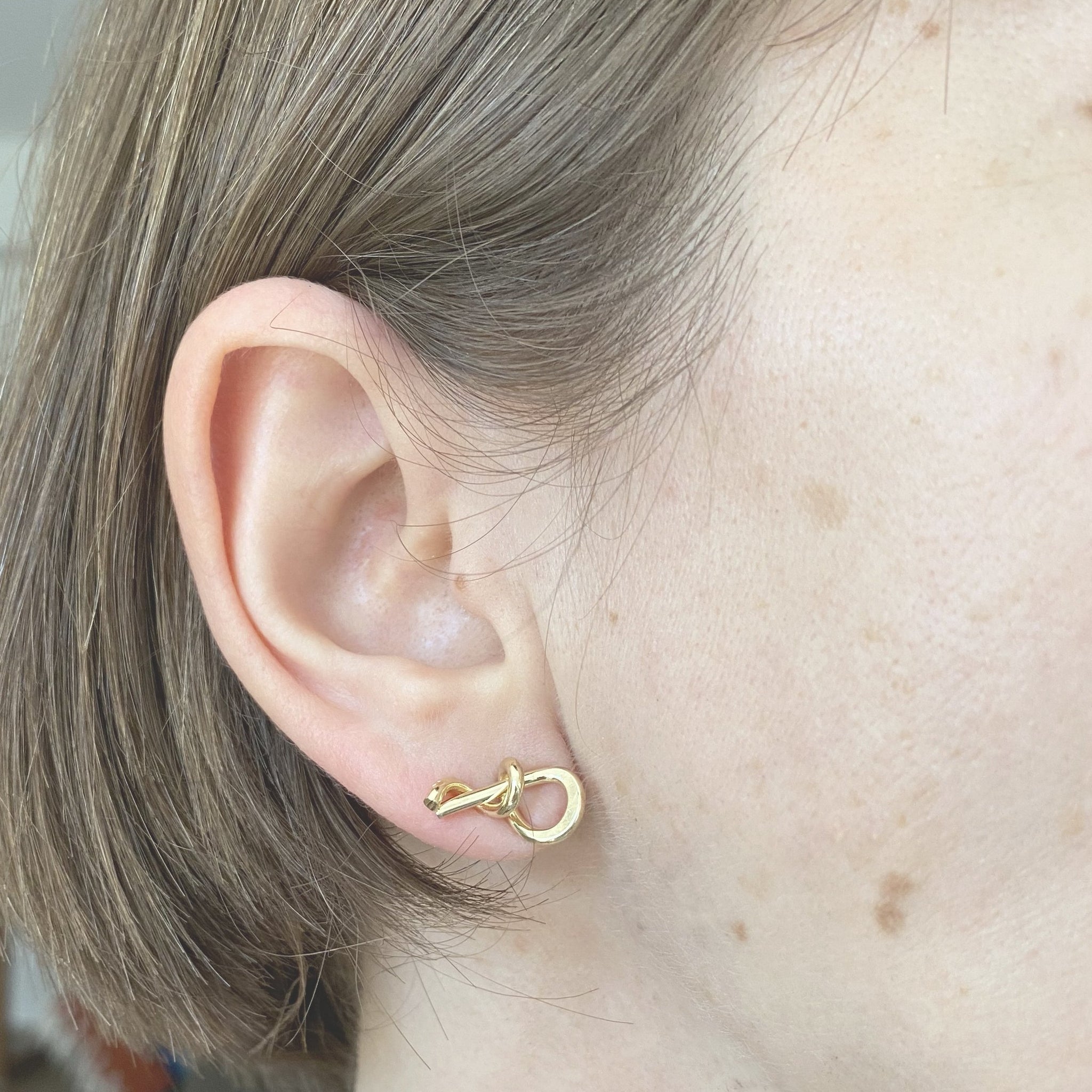 I am interested in smaller scale lately and Hooked up reflects that. Cute, every day studs!  They are about  Size is 1/2-3/4" long and each is unique as I am bending wire in a very tight curve and metal is unforgiving.  Gold plated brass, however should you be interested please email us, we also can make these in silver or gold. 