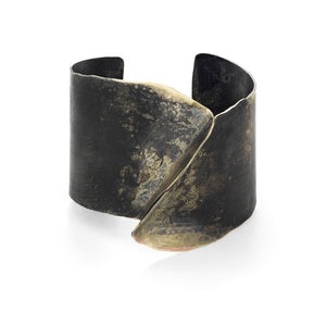 A sculptural cuff bracelet unique and for people (including men) that want to make a statement.  ~1.5 wide and the joined piece is about .75 " above the wrist.  Each piece is hand cut, formed, hammered. And each one is finished with a patina by hand thus rendering each piece unique.