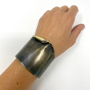 Wither is a Hand formed, hammered brass cuff bracelet finished with patina treatment.  Every cuff is cut and hammered by hand so each is slightly different in the fold and shape.  Sides are 1.75” wide and the section with the hammer and fold is around 2”.  its easily formed by hand so you can adjust the size to fit your wrist.  Gorgeous wearable sculpture for your hand.  Handmade in Brooklyn, NY